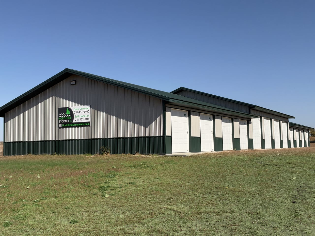 The end of the North Pine Storage building with the green North Pine Storage sign