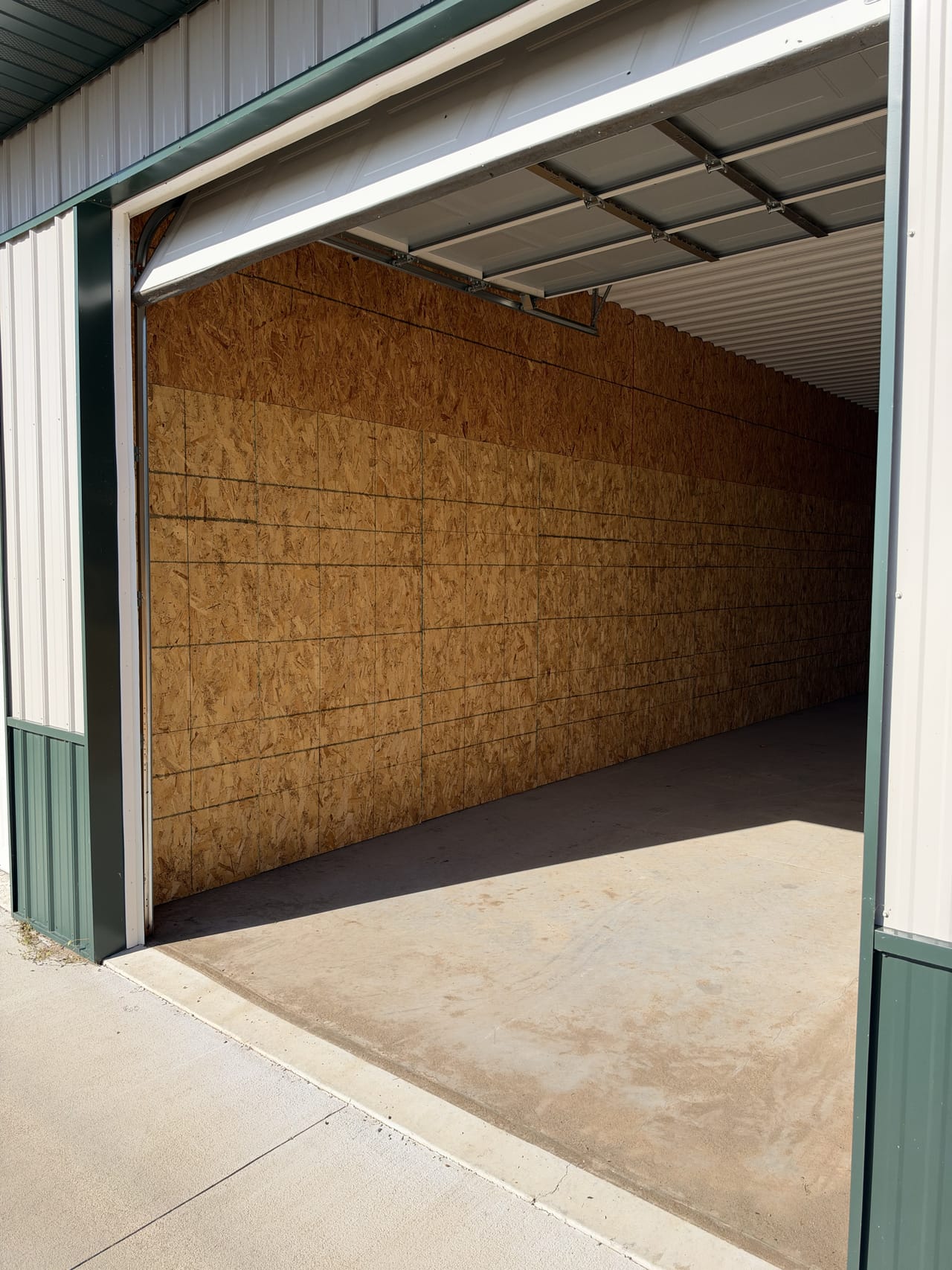 A large unit with its 10 x 10 overhead door open, showing the 40 ft deep plywood-lined interior